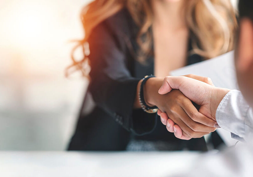 Businesswoman handshake and business people